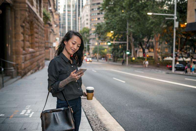 Young businesswoman waiting for taxi in Sydney 